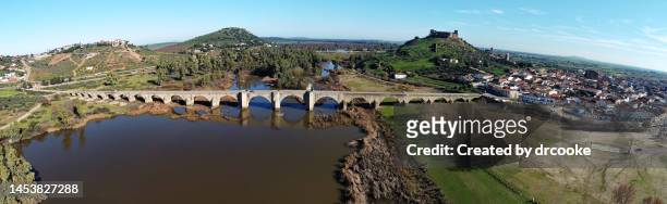 bridge over river guadiana in medellín, with castle in the background - extremadura stock pictures, royalty-free photos & images