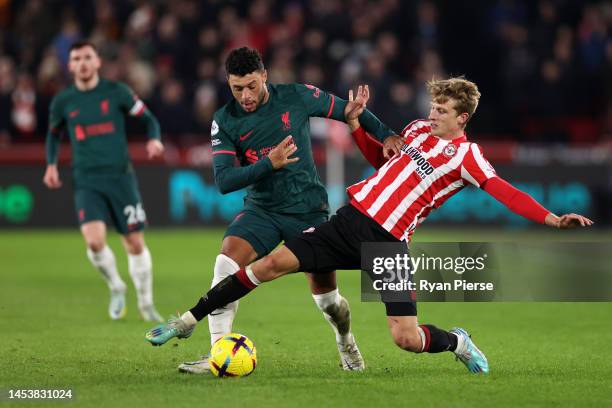 Mads Roerslev of Brentford battles for possession with Alex Oxlade-Chamberlain of Liverpool during the Premier League match between Brentford FC and...