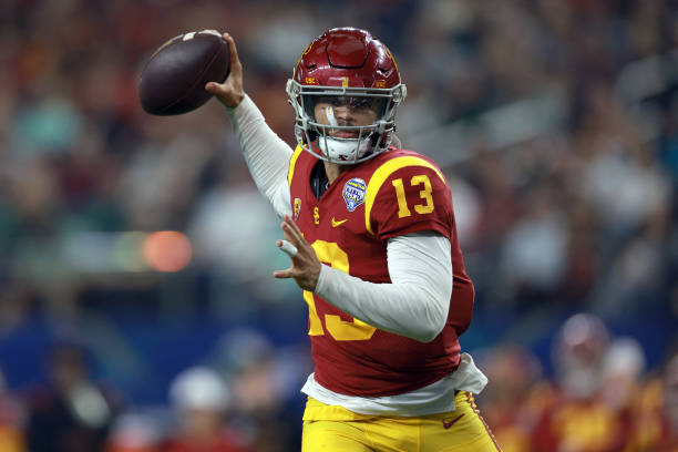 Caleb Williams of the USC Trojans throws a touchdown pass against the Tulane Green Wave in the second quarter of the Goodyear Cotton Bowl Classic on...