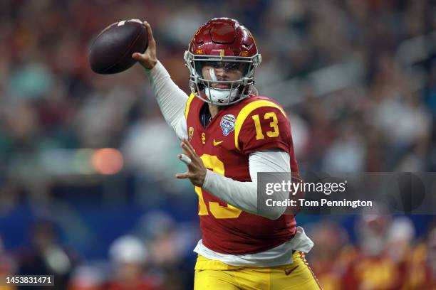 Caleb Williams of the USC Trojans throws a touchdown pass against the Tulane Green Wave in the second quarter of the Goodyear Cotton Bowl Classic on...