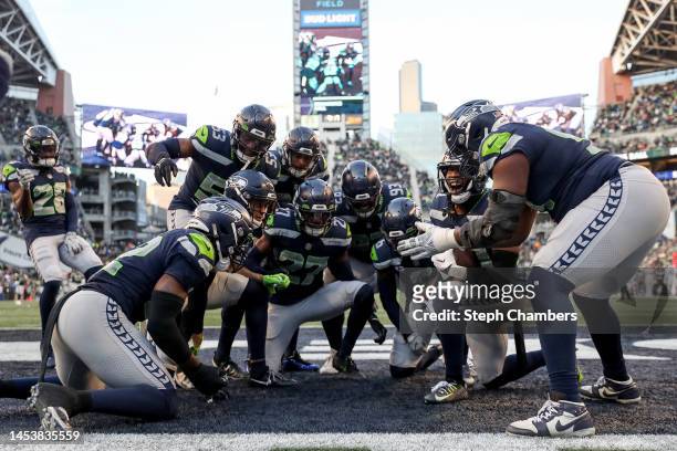 Mike Jackson of the Seattle Seahawks celebrates an interception with teammates during the fourth quarter in the game against the New York Jets at...