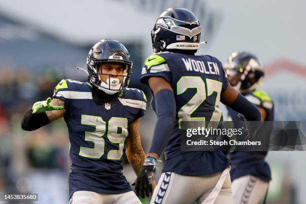 Teez Tabor and Tariq Woolen of the Seattle Seahawks react during the fourth quarter against the New York Jets at Lumen Field on January 01, 2023 in...