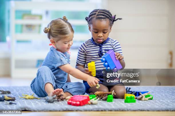 toddlers playing with toys - peuter stockfoto's en -beelden