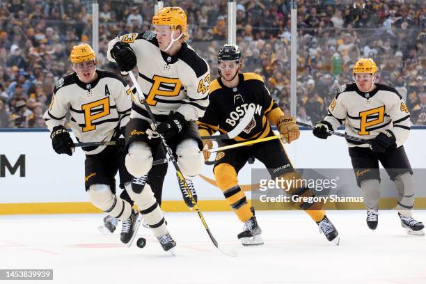 Danton Heinen of the Pittsburgh Penguins jumps over the puck during the first period against the Boston Bruins in the 2023 Discover NHL Winter...