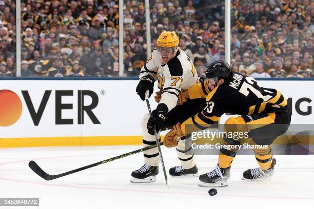 Evgeni Malkin of the Pittsburgh Penguins and Charlie McAvoy of the Boston Bruins compete for the puck during the first period in the 2023 Discover...