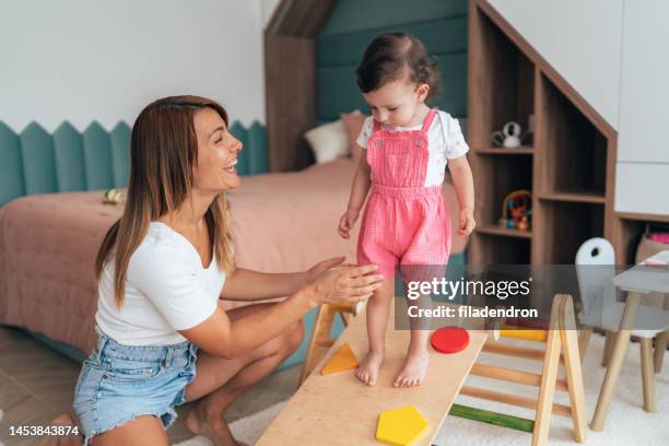 mother playing with toddler - montessori education stock pictures, royalty-free photos & images