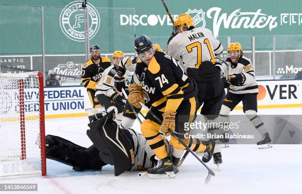 Jake DeBrusk of the Boston Bruins battles against Evgeni Malkin of the Pittsburgh Penguins during the first period of the 2023 Discover NHL Winter...