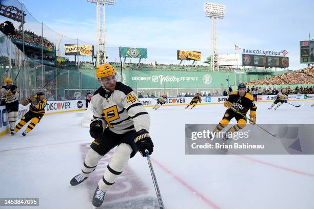 Jan Rutta of the Pittsburgh Penguins turns in the corner as Jake DeBrusk of the Boston Bruins pursues the play in the first period during the 2023...