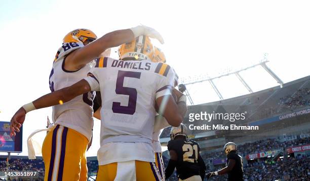 Jayden Daniels of the LSU Tigers celebrates a touchdown during the Cheez-It Citrus Bowl against the Purdue Boilermakers at Camping World Stadium on...