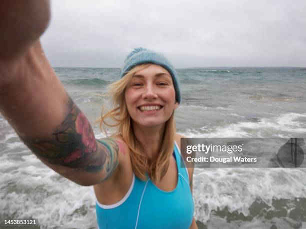 a woman in swimwear taking a selfie - beach selfie bildbanksfoton och bilder