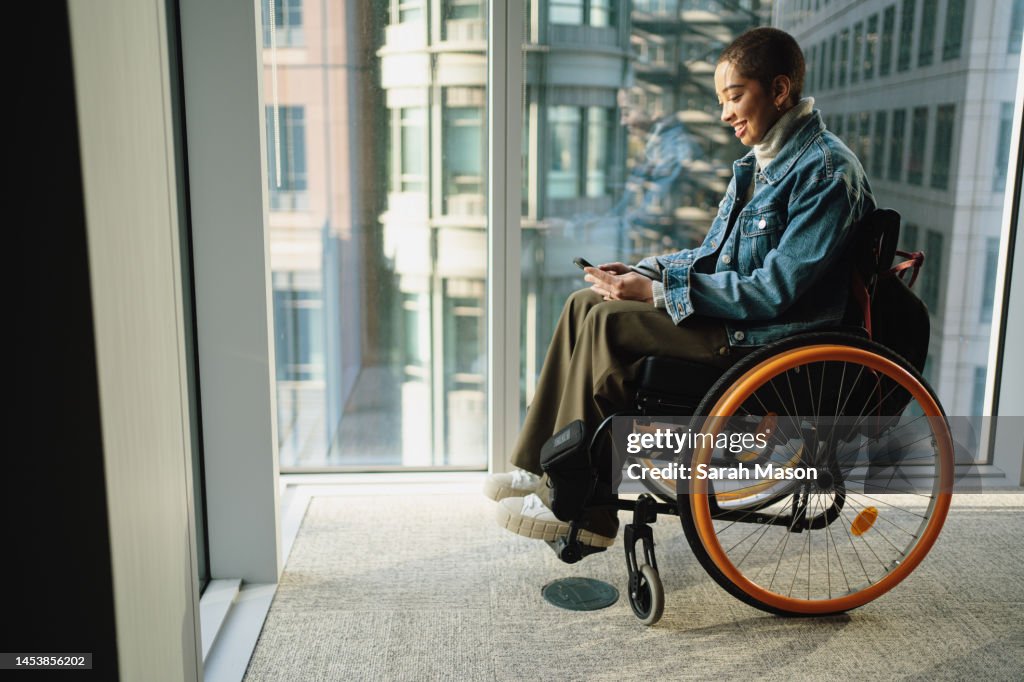Young office worker looking at phone