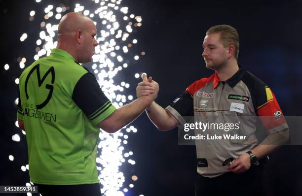 Dimitri Van den Bergh of Belgian and Michael van Gerwen of Netherlands shake hands after their Semi-Final Match during Day Thirteen of the at...