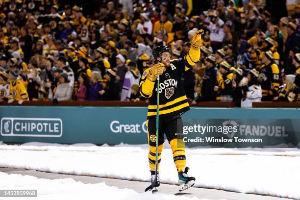 David Pastrnak of the Boston Bruins celebrates after defeating the Pittsburgh Penguins in the 2023 Discover NHL Winter Classic at Fenway Park on...