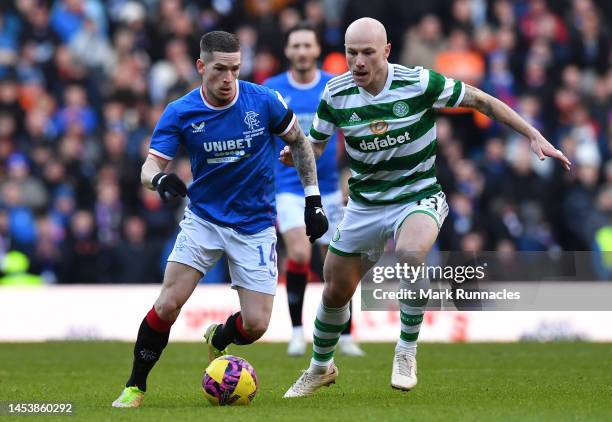 Ryan Kent of Rangers is challenged by Aaron Mooy of Celtic during the Cinch Scottish Premiership match between Rangers FC and Celtic FC at Ibrox...
