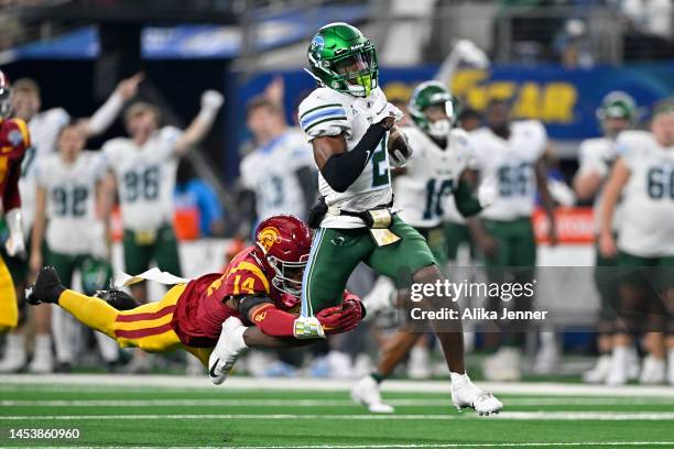 Defensive back Jacobe Covington of the USC Trojans dives at wide receiver Duece Watts of the Tulane Green Wave during the fourth quarter of the...