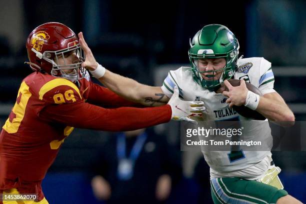 Michael Pratt of the Tulane Green Wave carries the ball against Nick Figueroa of the USC Trojans in the fourth quarter of the Goodyear Cotton Bowl...