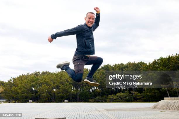 the man jumps. - male and wacky stock pictures, royalty-free photos & images