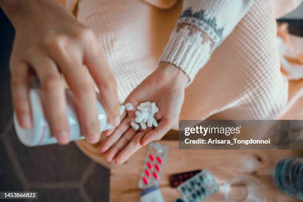 woman's hand and hand taking medicine - antidepressants stockfoto's en -beelden