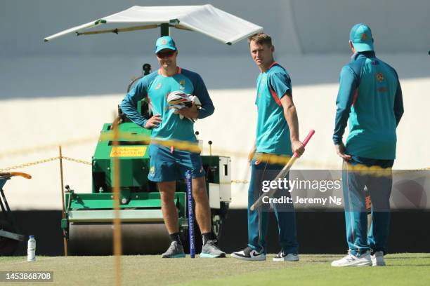 Marnus Labuschagne of Australia inspects the pitch with Marcus Harris and Steven Smith during an Australian Test squad training session at Sydney...