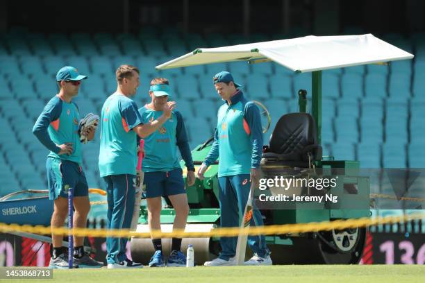 Marnus Labuschagne of Australia inspects the pitch with Marcus Harris and Steven Smith during an Australian Test squad training session at Sydney...