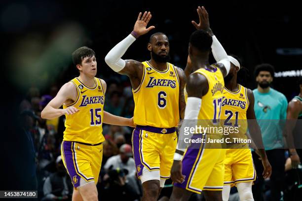 LeBron James of the Los Angeles Lakers reacts with his teammates following a basket during the second quarter of the game against the Charlotte...