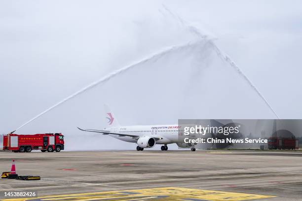 The first C919 large passenger aircraft of China Eastern Airlines passes a water gate after landing at Haikou Meilan International Airport during the...