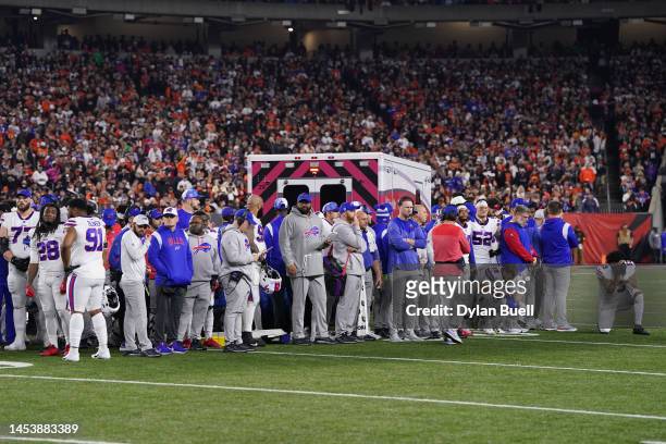 Buffalo Bills players look on after teammate Damar Hamlin collapsed on the field after making a tackle against the Cincinnati Bengals during the...