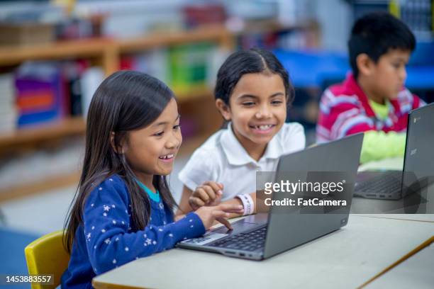 children in a computer lab - child using laptop stock pictures, royalty-free photos & images