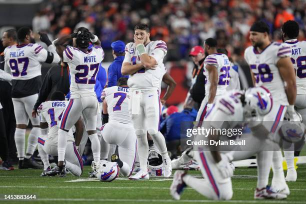 Josh Allen of the Buffalo Bills reacts to teammate Damar Hamlin collapsing after making a tackle against the Cincinnati Bengals during the first...