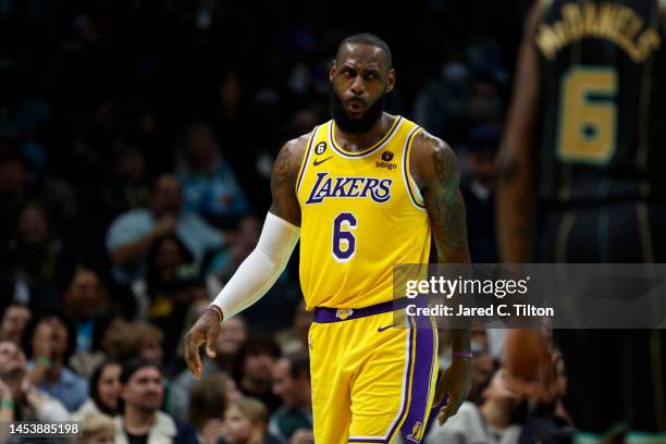 LeBron James of the Los Angeles Lakers reacts following a dunk during the second half of the game against the Charlotte Hornets at Spectrum Center on...