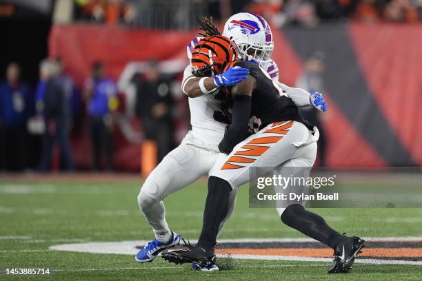 Damar Hamlin of the Buffalo Bills tackles Tee Higgins of the Cincinnati Bengals during the first quarter at Paycor Stadium on January 02, 2023 in...