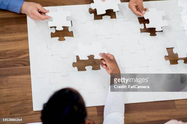 putting together a puzzle - arranging ideas stock pictures, royalty-free photos & images