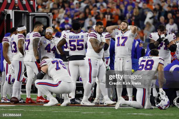 Buffalo Bills players react after teammate Damar Hamlin was injured against the Cincinnati Bengals during the first quarter at Paycor Stadium on...