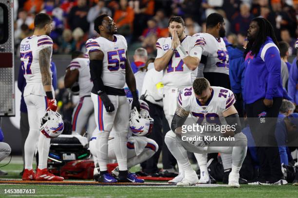 Buffalo Bills players react after teammate Damar Hamlin was injured against the Cincinnati Bengals during the first quarter at Paycor Stadium on...
