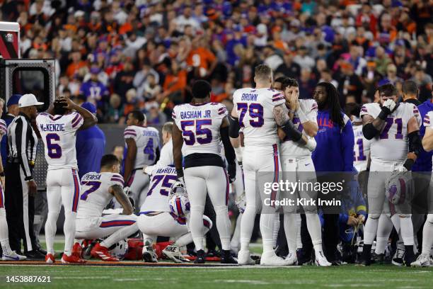 Buffalo Bills players react after teammate Damar Hamlin was injured against the Cincinnati Bengals during the first quarter at Paycor Stadium on...