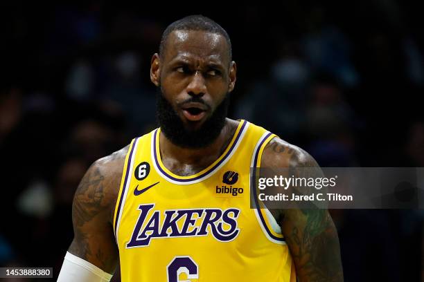 LeBron James of the Los Angeles Lakers reacts following a dunk during the second half of the game against the Charlotte Hornets at Spectrum Center on...