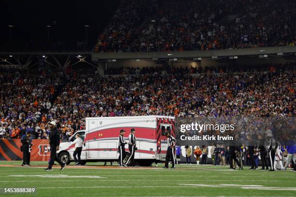 Fans look on as the ambulance leaves carrying Damar Hamlin of the Buffalo Bills after he collapsed after making a tackle against the Cincinnati...