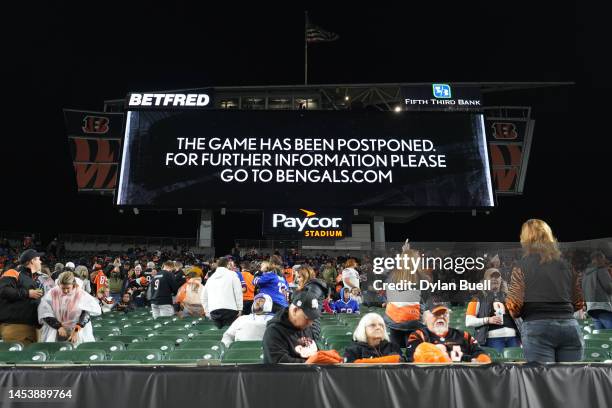 An announcement is displayed on the scoreboard as the game between the Cincinnati Bengals and the Buffalo Bills is postponed following the injury of...
