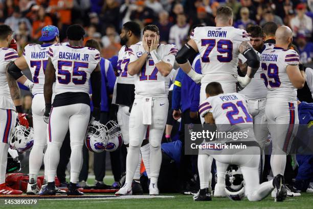 Buffalo Bills players react after teammate Damar Hamlin was injured against the Cincinnati Bengals during the first quarter at Paycor Stadium on...