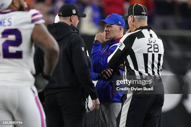 Head coach Sean McDermott of the Buffalo Bills and head coach Zac Taylor of the Cincinnati Bengals speak during the suspension of their game...