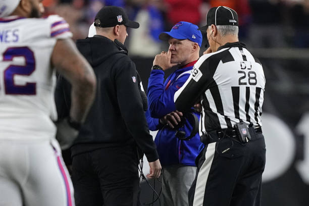 Head coach Sean McDermott of the Buffalo Bills and head coach Zac Taylor of the Cincinnati Bengals speak during the suspension of their game...