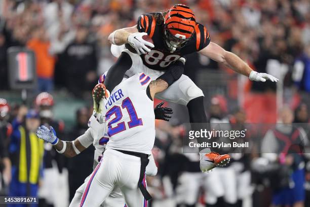 Hayden Hurst of the Cincinnati Bengals attempts to hurdle Jordan Poyer of the Buffalo Bills following his reception during the first quarter at...