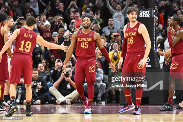 Raul Neto and Cedi Osman celebrate with Donovan Mitchell of the Cleveland Cavaliers after Mitchell hit a free throw in the final seconds of overtime...