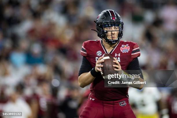 Spencer Rattler of the South Carolina Gamecocks looks to pass against the Notre Dame Fighting Irish during the second half of the TaxSlayer Gator...