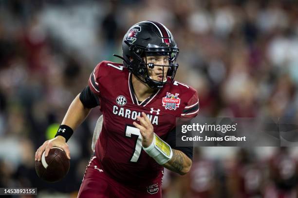Spencer Rattler of the South Carolina Gamecocks looks to pass against the Notre Dame Fighting Irish during the second half of the TaxSlayer Gator...