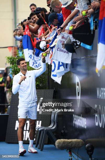 Novak Djokovic of Serbia signs autographs for the Serbian fans after winning his match against Constant Lestienne of France during day three of the...
