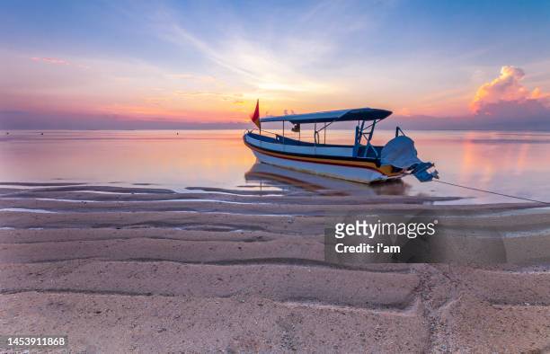 stunning beautiful sunlight beach with fishing boats on a beach. sanur beach, bali, indonesia. - sanur stock pictures, royalty-free photos & images