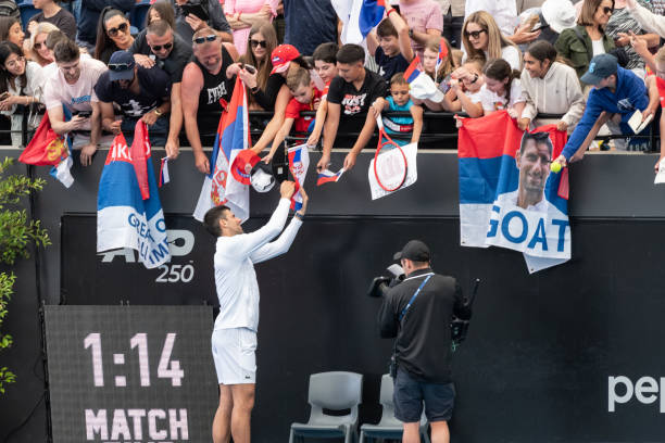 Novak Djokovic of Serbia signs autographs after winning his match against Constant Lestienne of France during day three of the 2023 Adelaide...