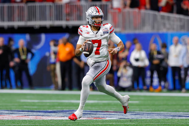 Stroud of the Ohio State Buckeyes rolls out in the first half against the Georgia Bulldogs in the Chick-fil-A Peach Bowl at Mercedes-Benz Stadium