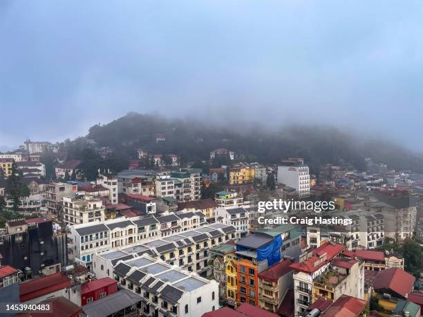 sapa, vietnam - high angle view of sapa roof tops as houses, apartments and hotels climb up the mountainside - sa pa stock pictures, royalty-free photos & images